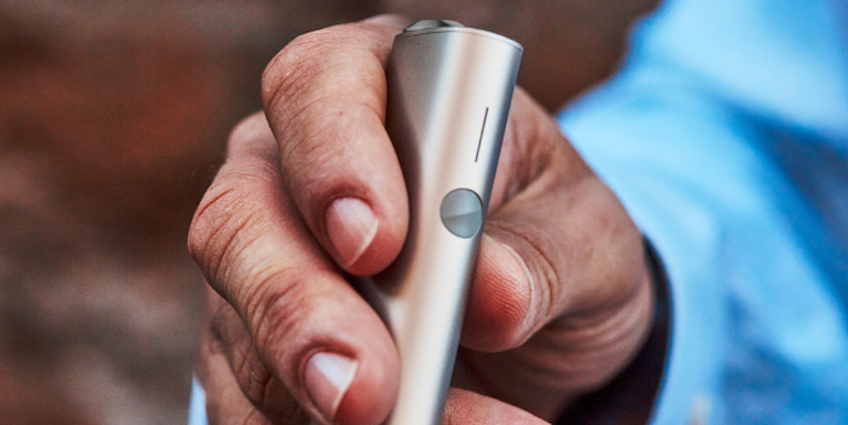 A hand holding a sheet of paper.