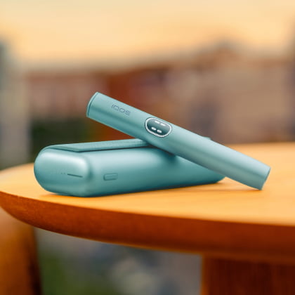 A jade green IQOS ILUMA i PRIME Pocket Charger and Holder.